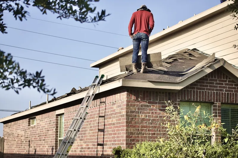 Professional roofer working on a residential roof in South Killingly